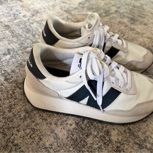 Woman’s white and navy blue New Balance, size 8, worn a few times,  comfortable